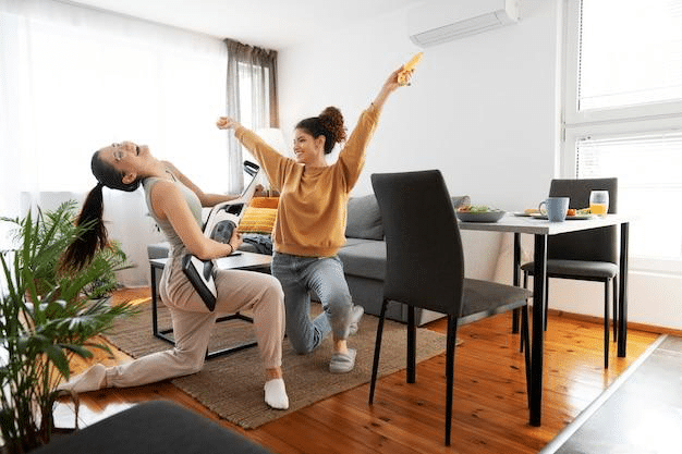 Two ladies playing music and enjoying indoors