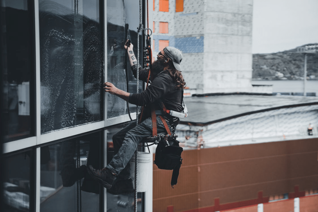 A professional doing high-rise window cleaning