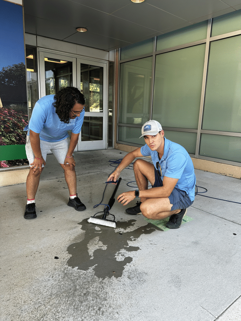 A team of commercial window cleaners working on the exterior of a business building in Westlake.