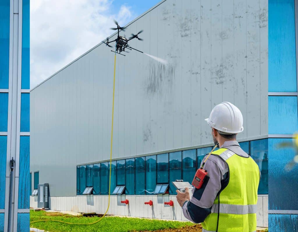 Commercial drone pressure washing service cleaning a building exterior in Dallas.
